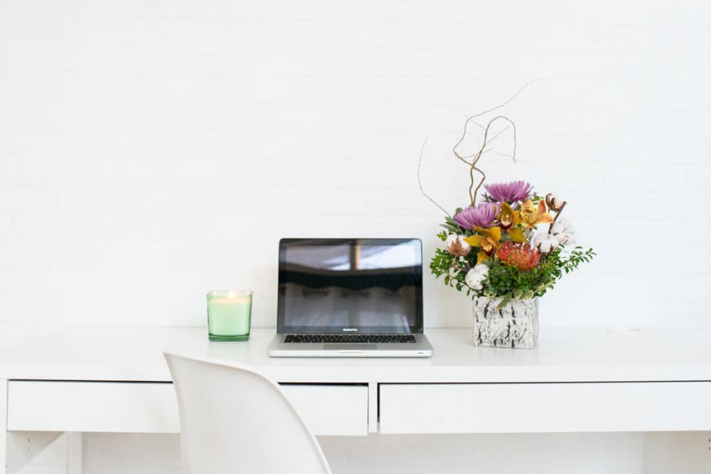 flower decor on laptop table